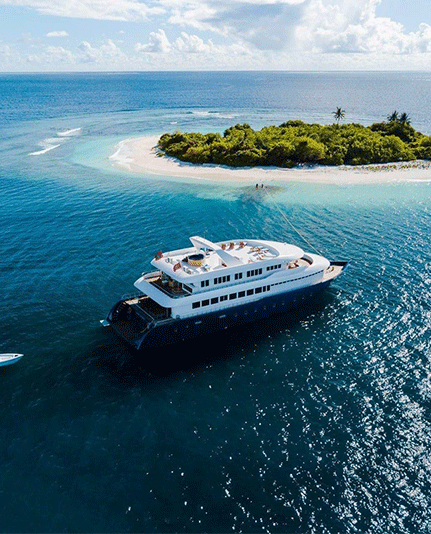 Luxury yacht anchored near a private island — private island cruise package
